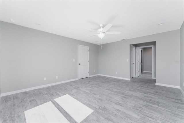 empty room with light wood-type flooring and ceiling fan