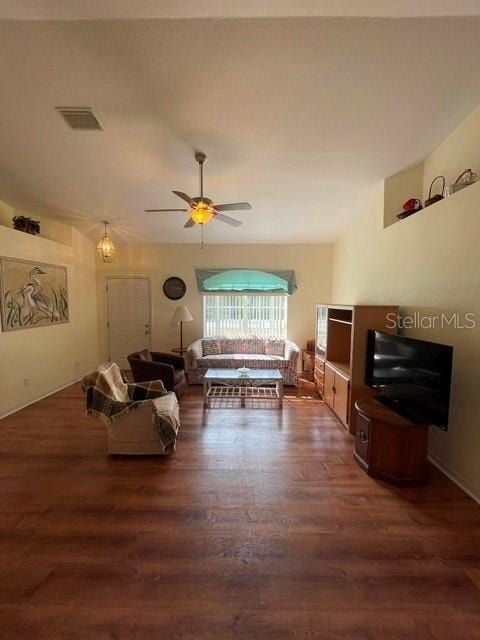 living room with ceiling fan and dark wood-type flooring