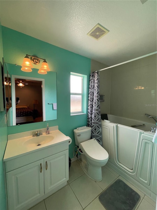 full bathroom with toilet, shower / tub combo with curtain, tile patterned floors, a textured ceiling, and vanity