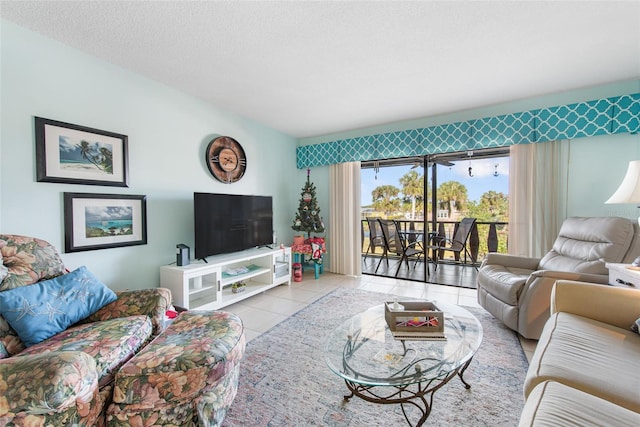 living room with light tile patterned flooring and a textured ceiling