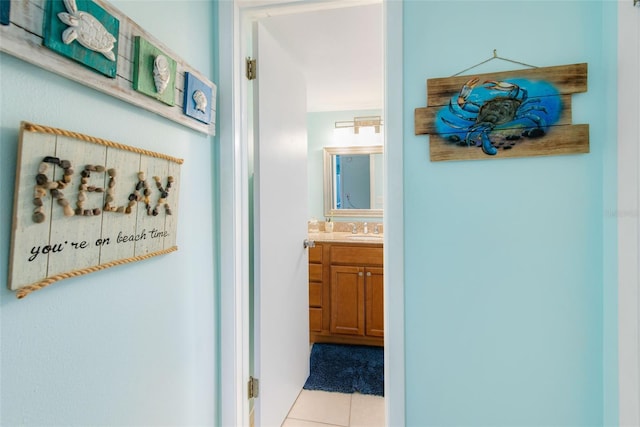 hallway with light tile patterned flooring and sink