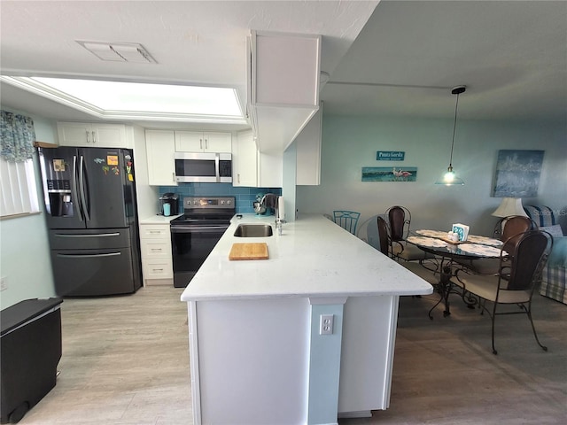 kitchen with kitchen peninsula, range with electric cooktop, sink, fridge with ice dispenser, and white cabinets