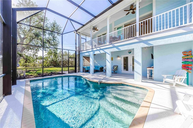 view of pool with a patio, french doors, ceiling fan, and a lanai