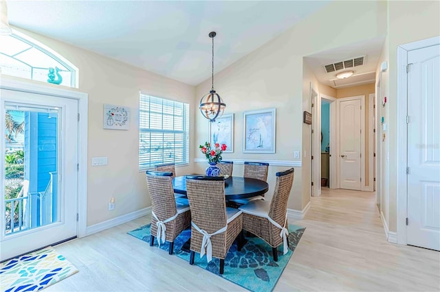13104 Via Cassia, Placida, FL 33946 - dining space with light wood-type flooring, vaulted ceiling, and a chandelier