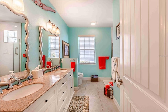 bathroom featuring toilet, vanity, and an enclosed shower