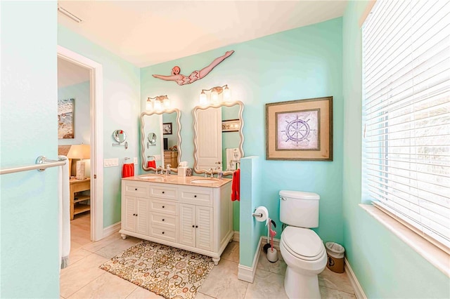 bathroom featuring tile patterned floors, toilet, and vanity