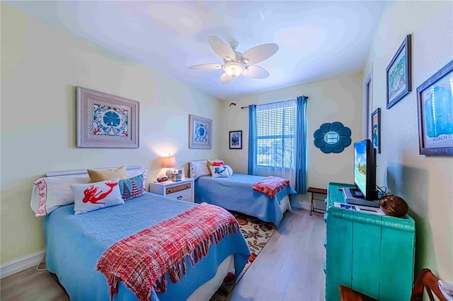 bedroom with ceiling fan and light hardwood / wood-style floors