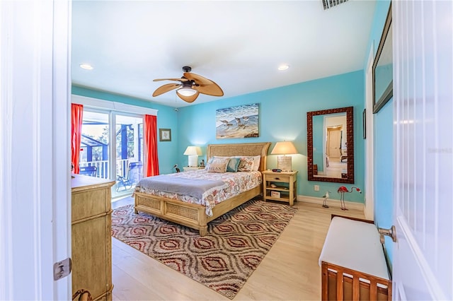 bedroom featuring light hardwood / wood-style flooring, ceiling fan, and access to outside