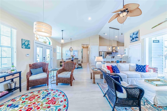 living room featuring light wood-type flooring, french doors, high vaulted ceiling, and ceiling fan