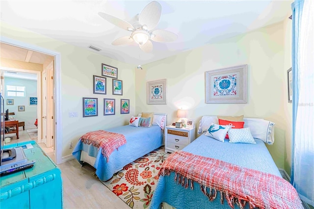 bedroom with light hardwood / wood-style flooring and ceiling fan