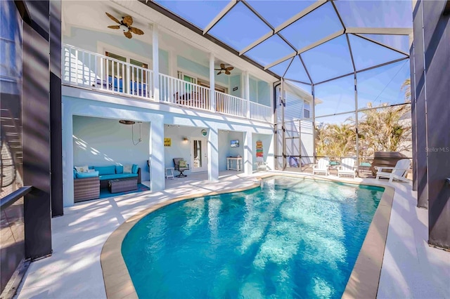 view of pool featuring a patio, ceiling fan, a lanai, and an outdoor hangout area