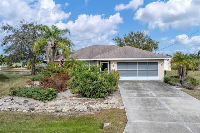 single story home featuring a front lawn and a garage