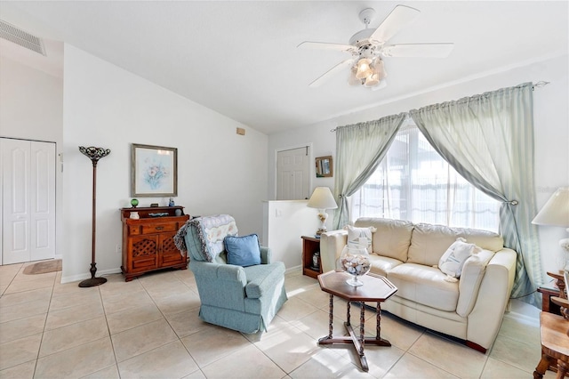 tiled living room with ceiling fan and lofted ceiling