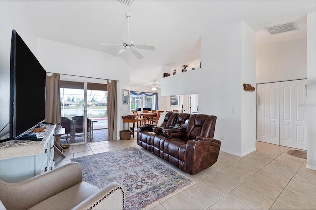 living room with ceiling fan, light tile patterned floors, and high vaulted ceiling