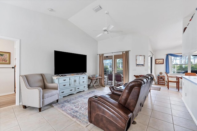 living room with high vaulted ceiling, a wealth of natural light, and light tile patterned flooring