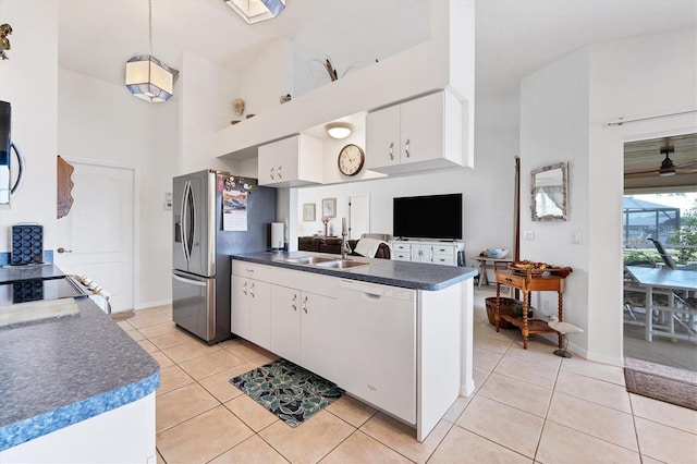 kitchen featuring white cabinetry, dishwasher, light tile patterned floors, and high vaulted ceiling