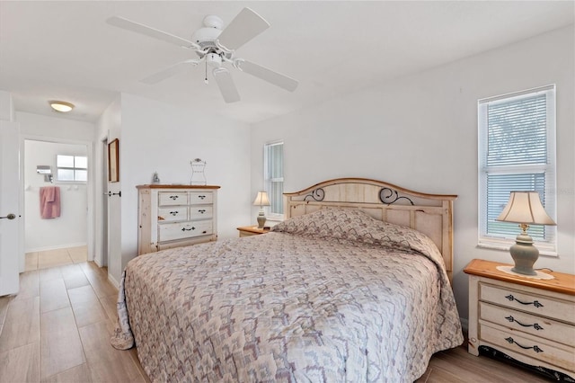 bedroom with multiple windows, ceiling fan, and light hardwood / wood-style floors