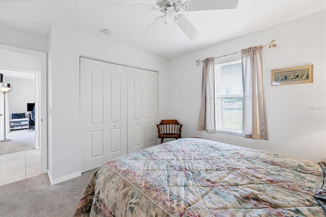 carpeted bedroom with ceiling fan and a closet