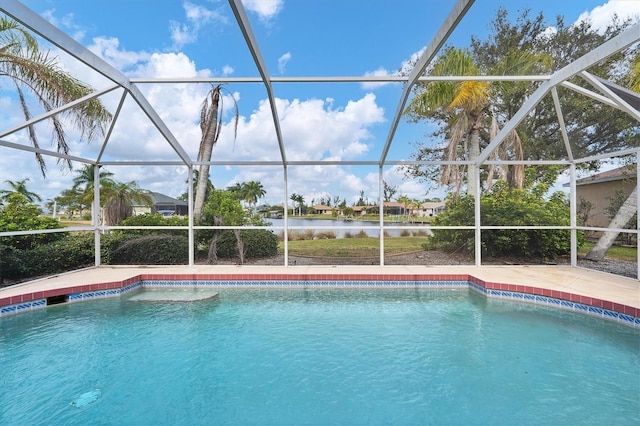 view of pool with a water view and glass enclosure