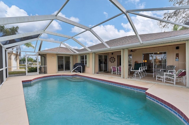 view of swimming pool featuring a lanai and a patio