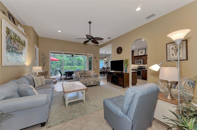 tiled living room with ceiling fan