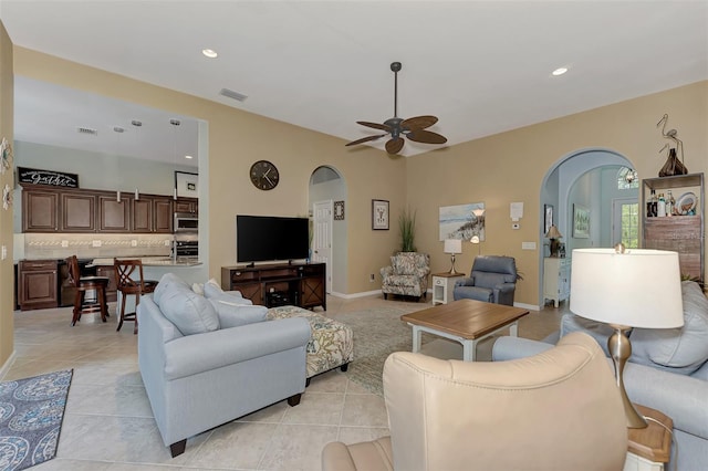 tiled living room featuring ceiling fan