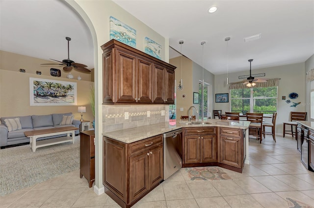 kitchen featuring stainless steel dishwasher, kitchen peninsula, hanging light fixtures, and light tile patterned floors