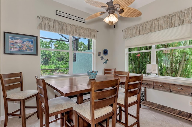 dining space with ceiling fan and light tile patterned floors