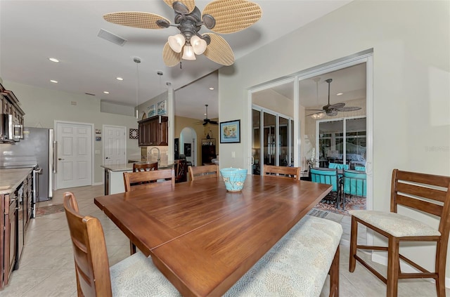 tiled dining space with ceiling fan