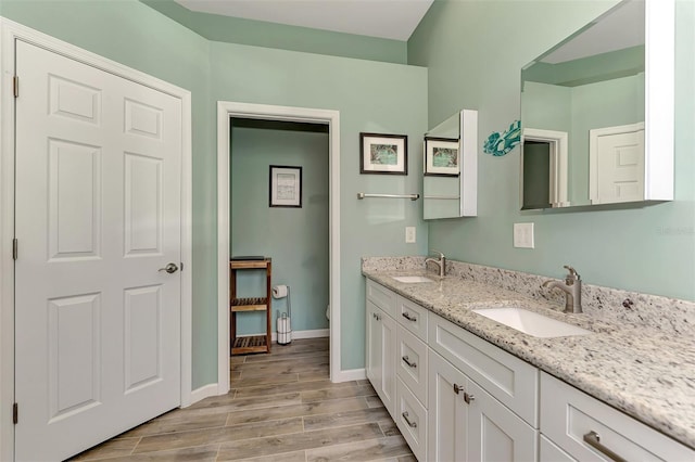 bathroom with hardwood / wood-style floors, vanity, and toilet