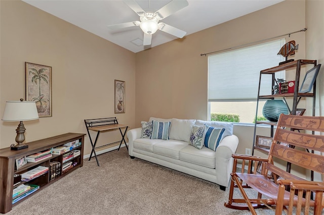 carpeted living room with ceiling fan