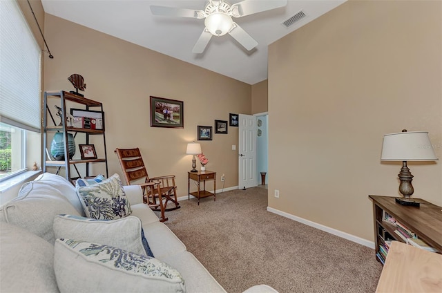 carpeted living room with ceiling fan