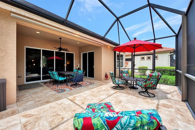 view of patio with glass enclosure and ceiling fan