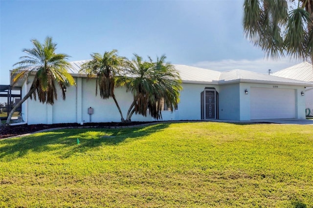 view of front of property with a front yard and a garage