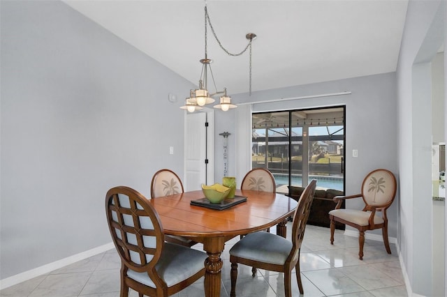 dining space with vaulted ceiling and light tile patterned flooring