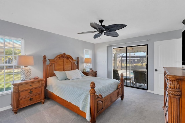 carpeted bedroom with ceiling fan, access to exterior, and multiple windows