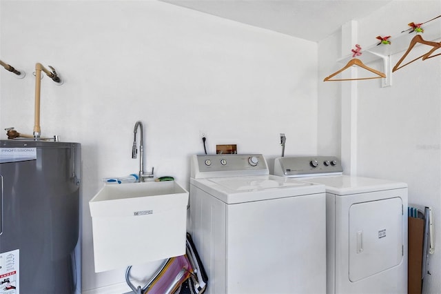 laundry room featuring electric water heater, washing machine and dryer, and sink