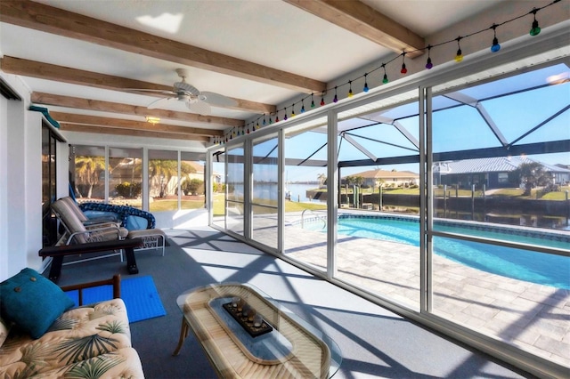 unfurnished sunroom featuring beam ceiling, ceiling fan, and a water view