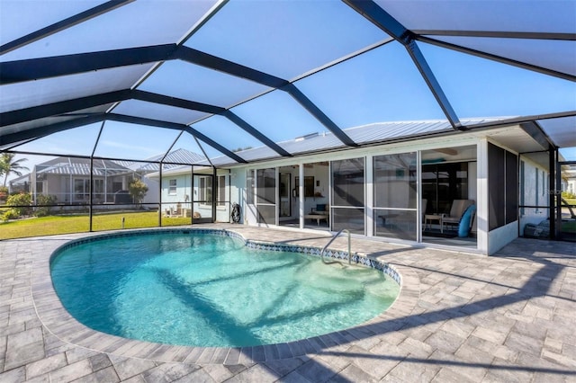 view of swimming pool featuring a patio and a lanai