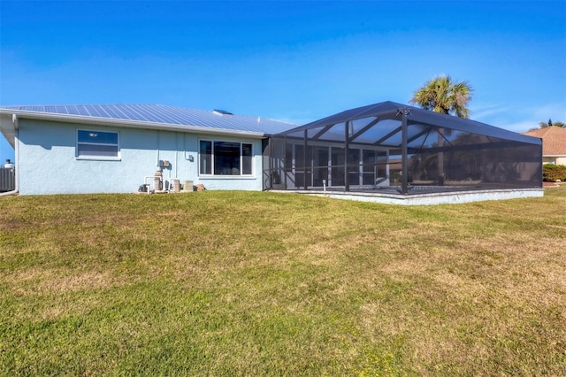 back of property with a yard, central AC, and a lanai