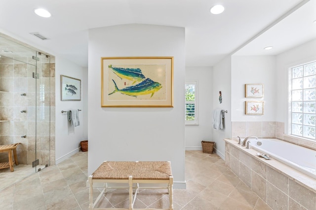 bathroom featuring tile patterned flooring and separate shower and tub