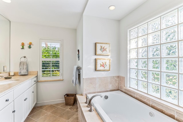 bathroom featuring tile patterned floors, tiled tub, and vanity