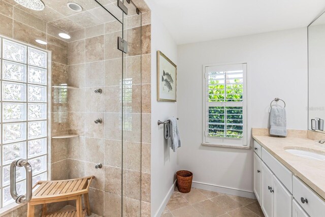 bathroom featuring vanity, tile patterned floors, and an enclosed shower