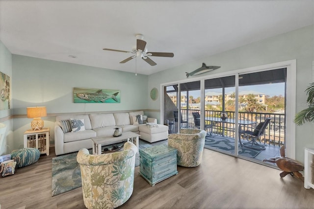 living room with ceiling fan and hardwood / wood-style flooring