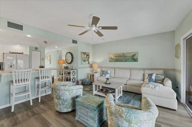 living room featuring ceiling fan and wood-type flooring