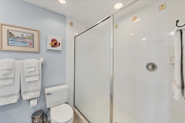 bathroom with toilet and walk in shower