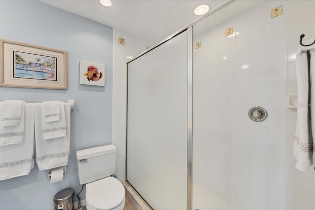 full bathroom with a stall shower and toilet