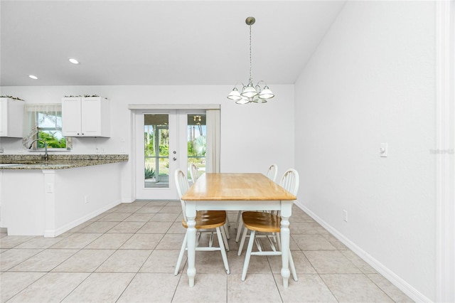 unfurnished dining area with french doors, sink, and light tile patterned floors