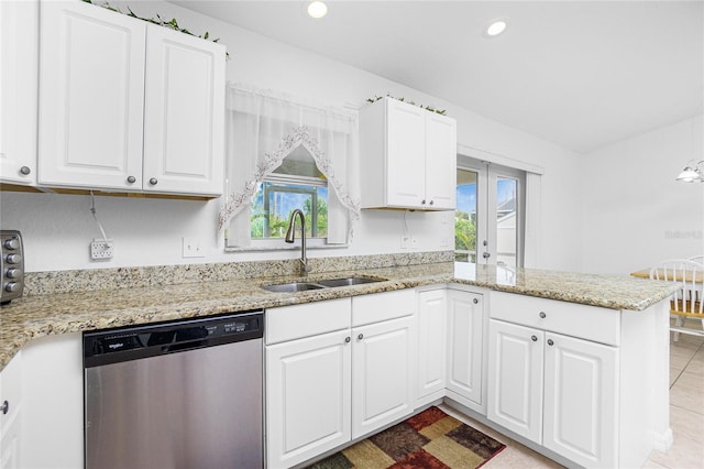 kitchen featuring sink, light stone counters, dishwasher, kitchen peninsula, and white cabinets