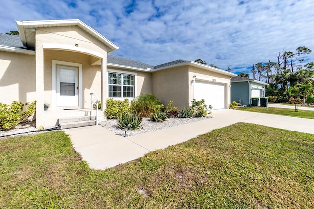 single story home with a garage and a front lawn